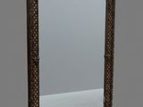 an old mirror with a wooden frame and a decorative design