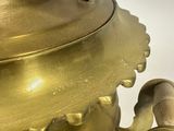 a gold vase with a handle on a white background