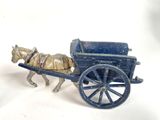 a toy horse pulling a carriage with a man on it