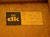 a close up of a wooden door with a name tag on it