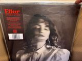 an image of a person holding up a magazine with a picture of a woman