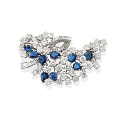a close up of a brooch with blue and white stones