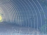 a horse that is standing inside of a metal structure