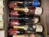 many bottles of wine in a box on the floor