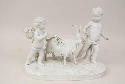a statue of a boy and a girl with a goat