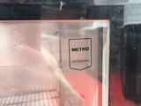 a cat that is sitting inside of an oven