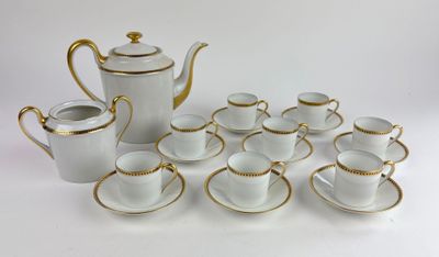 a lot of cups and saucers sitting on a table