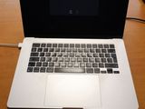 a laptop computer sitting on a wooden desk