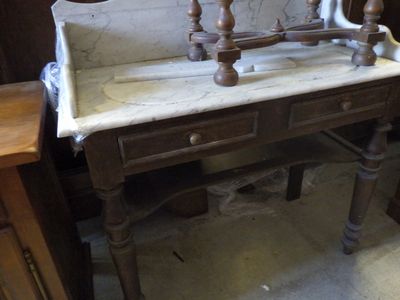 a marble sink sitting on top of a wooden table