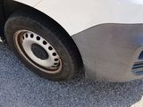 a close up of a white car with a flat tire