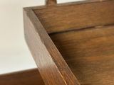 a close up of a wooden drawer with a drawer underneath it