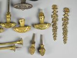 a lot of brass items that are on the table
