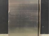an image of a stainless steel refrigerator in a warehouse