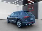 the rear end of a blue volkswagen suv parked in a garage