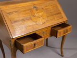 an old wooden desk with two drawers and a clock on the top