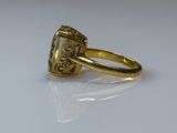 a close up of a gold ring with a diamond in the center
