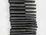 a bunch of black rods sitting on top of a white surface