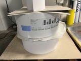 a white bucket with a box on top of it on a table