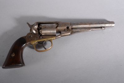 a close up of a revolver on a table with a white background