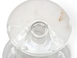 underside view of a clear glass candle holder on a white background