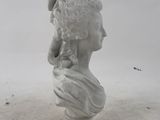 marble bust of a woman with a flower in her hair