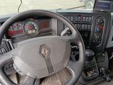 steering wheel and dashboard of a vehicle with a cell phone on the dashboard