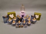 many small bottles of perfume sitting on a table