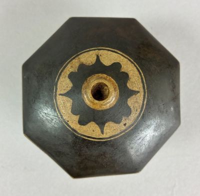 a black and gold vase with a flower design on it