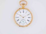 a gold pocket watch with roman numerals on the face