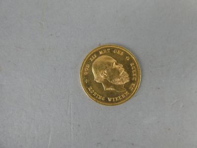 a gold coin with a picture of a man ' s face on it