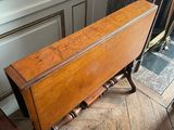 a small table with a wooden top on a wooden floor