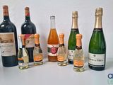 bottles of wine are lined up on a white surface