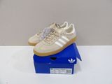adidas gazelle trainers in beige and white on a blue box