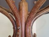 a close up of a wooden chandelier with a mirror