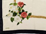 a black and white scarf with flowers on it