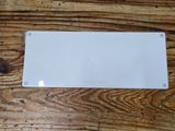 a white sign that is on a wooden table