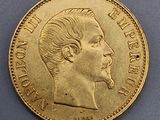 a close up of a gold coin with a man ' s face on it