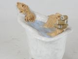 a teddy bear sitting in a bathtub with a teddy bear in it
