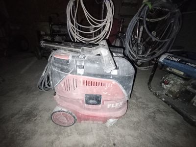 un aspirateur rose posé par terre dans un garage