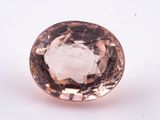 a close up of a pink diamond on a white surface