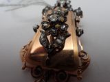 a gold purse with a flower on it on a table