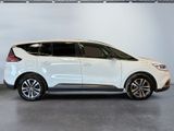 the white car is parked in a garage with a white wall