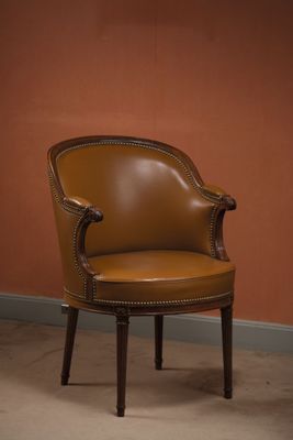 an image of a brown leather chair in a room with a red wall