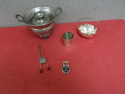 a red table with a silver bowl, spoon, and other items on it