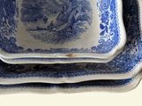 three blue and white plates stacked on top of each other