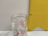 a glass jar with a cartoon character inside of it