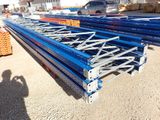 a large pile of steel beams sitting on the ground