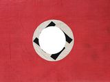 an old red and black flag with a white circle in the center