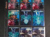 the four cards have different designs on them on a black surface