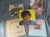 a picture of a bunch of album covers on a bed